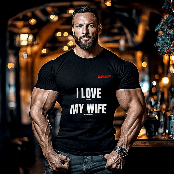 A man wearing a black t shirt that says 'I love it when my wife let's me go out'